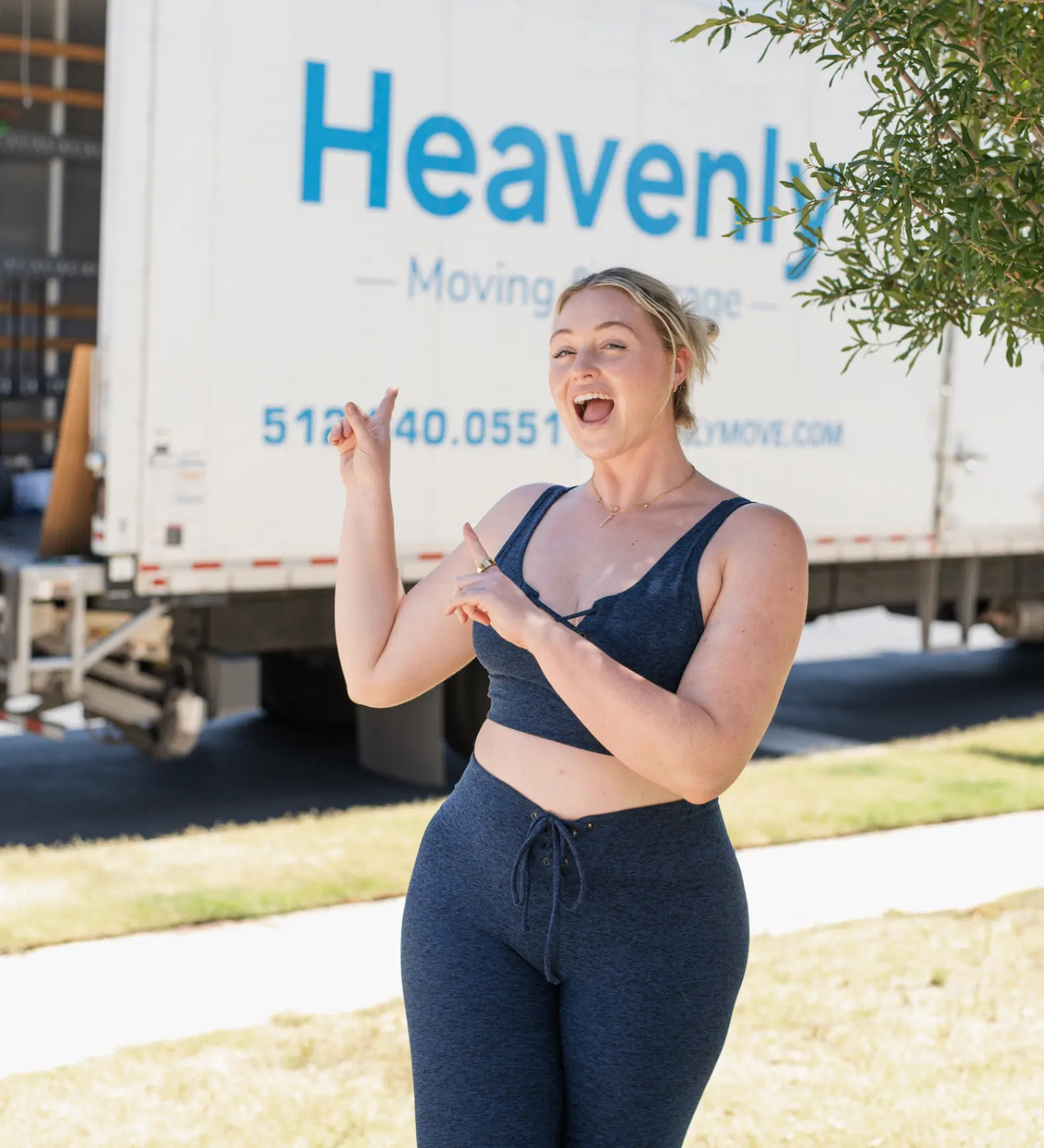 Heavenly Moving customer Iskra in front of a Heavenly Moving truck at her Circle C home.