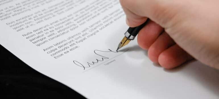 a hand signing documents