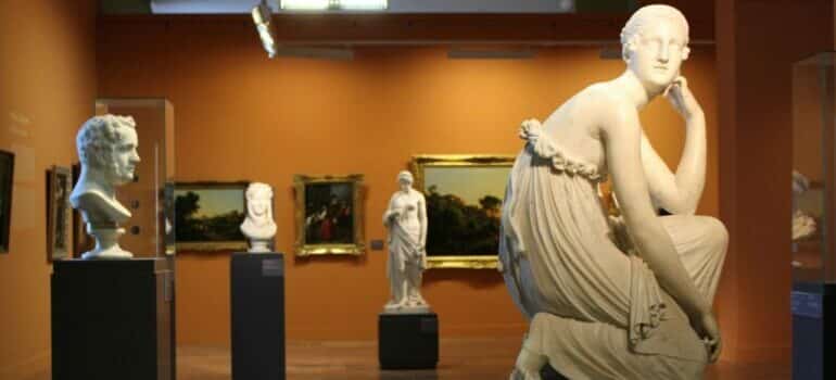 statues and paintings on display in a museum