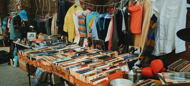 a variety of books, comics, records and clothes at a pre-move garage sale