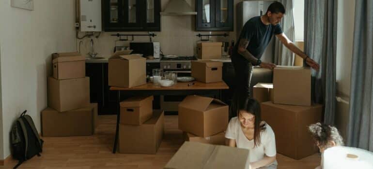 a family unpacking their items in the kitchen as something to do on your first day in your new home