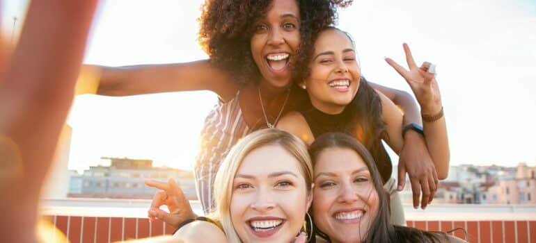 four women taking a selfie together at one of many rooftop bars in Austin