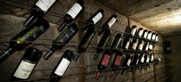 a collection of wine handing in the cellar before moving a wine collection to another location