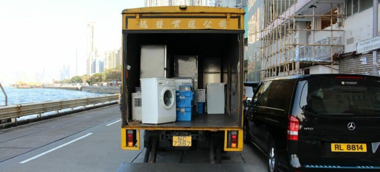 a truck transporting different household appliances to increase home space as a way that storage can help your home rental endeavors