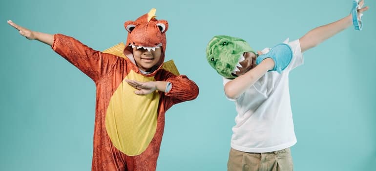 Two kids are posing for a picture once more before you pack Halloween costumes