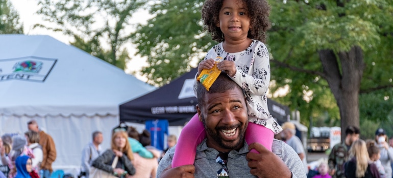 a father carrying his daughter on his back in one of Austin March 2022 events you should not miss