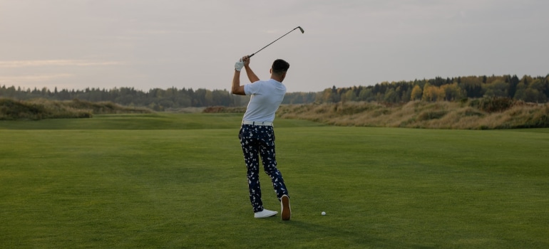 a man on the golf course hitting the ball