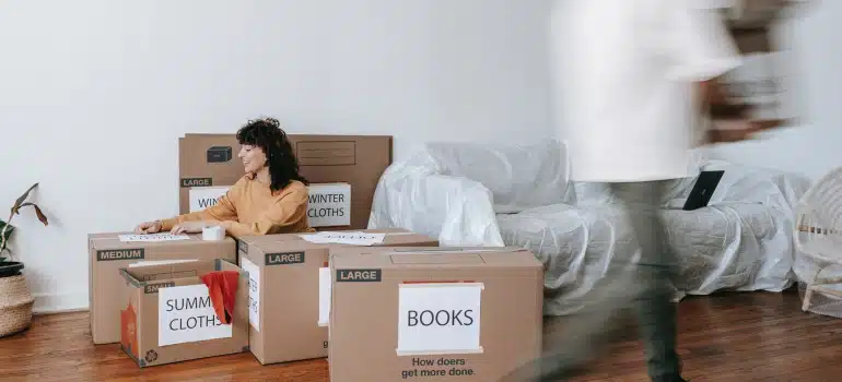 a couple packing their living room together