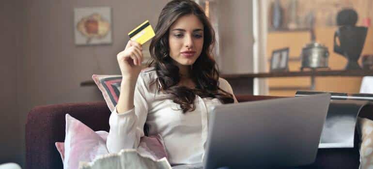 A woman looking at what to shop online with her credit card