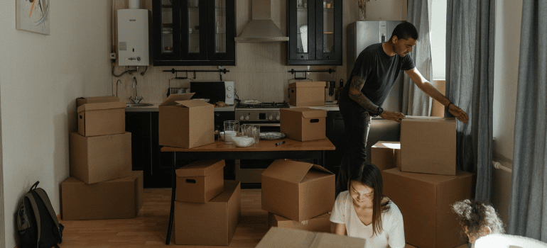 two people unpacking boxes