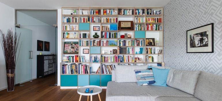 a living room with a large bookshelf full of books and other items