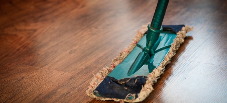 a mop on the dark wooden floor