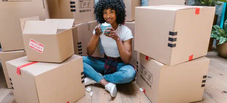 a girl gathering packing supplies before packing your artwork for storage