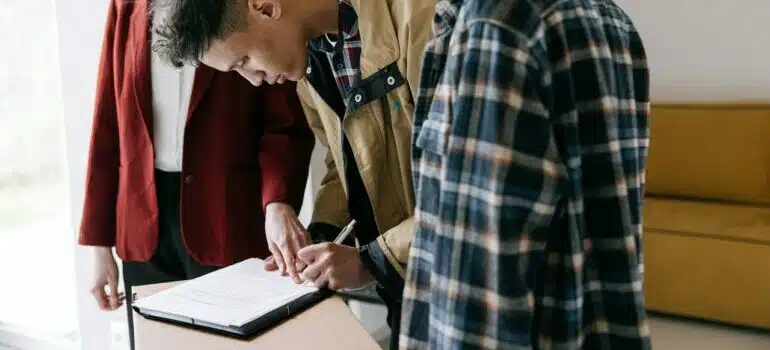 Young man signing a lease for renting his first Austin house