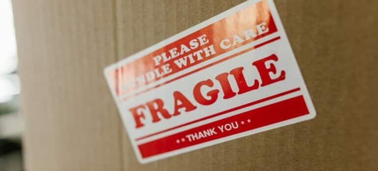 a brown cardboard box with a sticker fragile