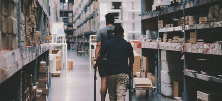 Two man walking in the climate controlled warehouse;