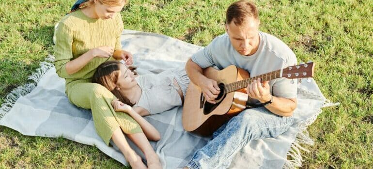 Family enjoying outdoor with guitar is just another reasons why you should live in North Austin 