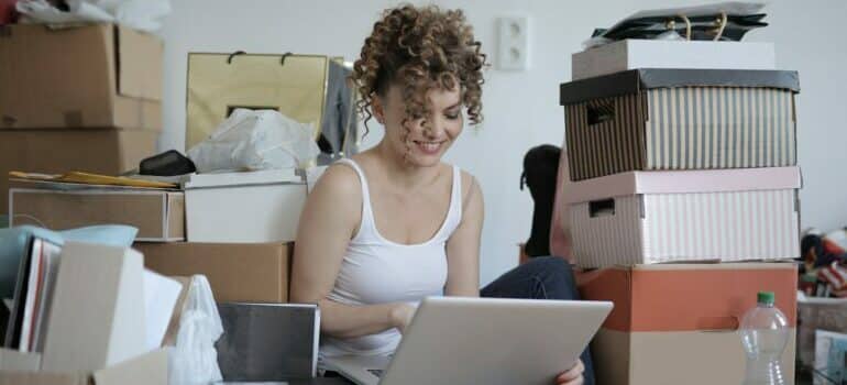 Women sitting with laptop with boxes around 