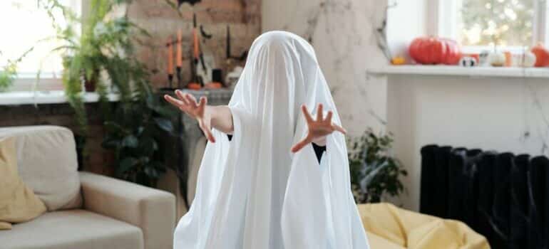 Kid in ghost Halloween costume