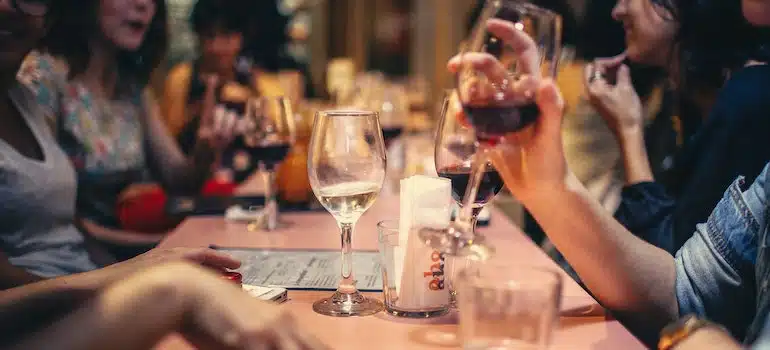 People drinking liquor and talking on dining table close-up photo more info share more like this