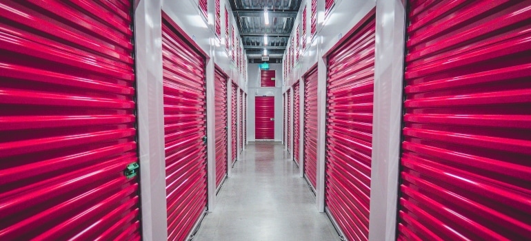 Corridor with storage unit doors that help you decide between storage units and moving containers