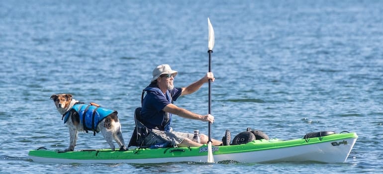 A Man Kayaking with His Dog